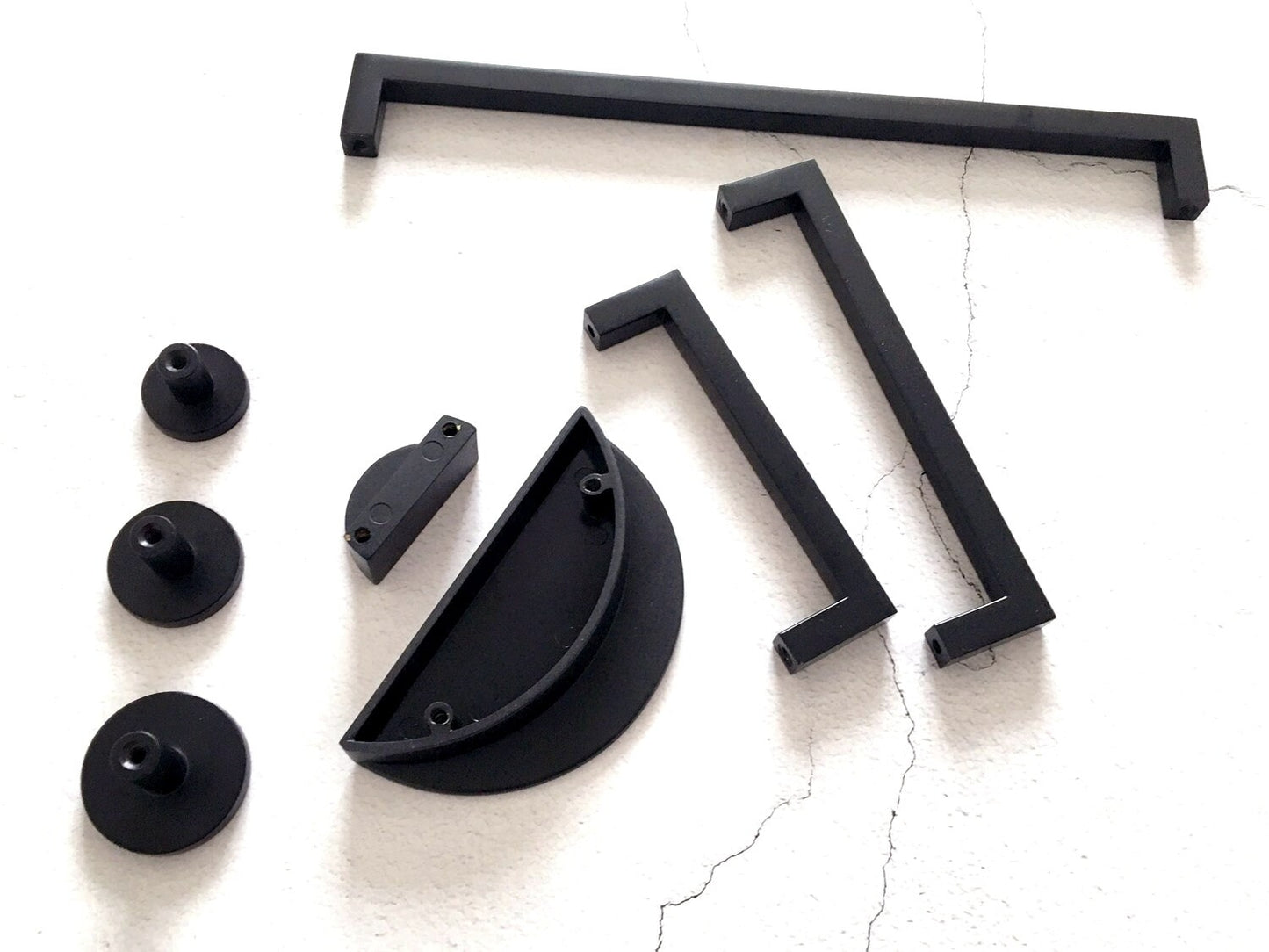 Black metal hardware components on a white background