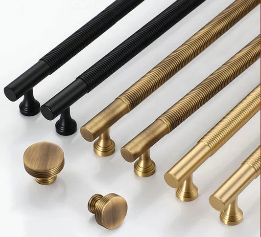 Set of black, bronze and gold cabinet handles on a white background