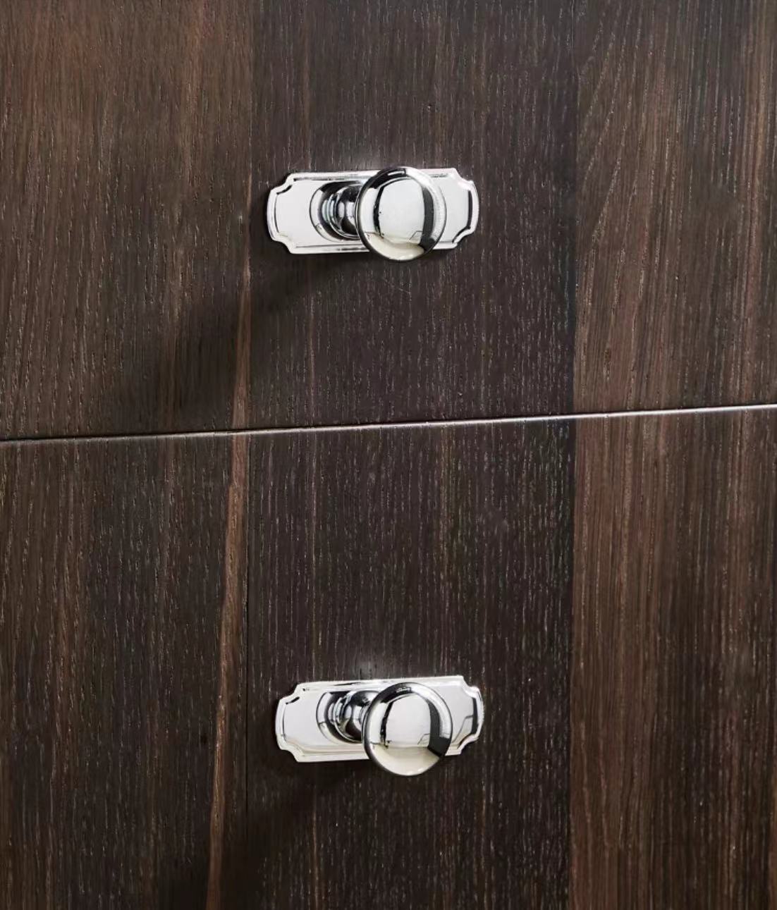 Close-up of wooden cabinet doors with silver handles