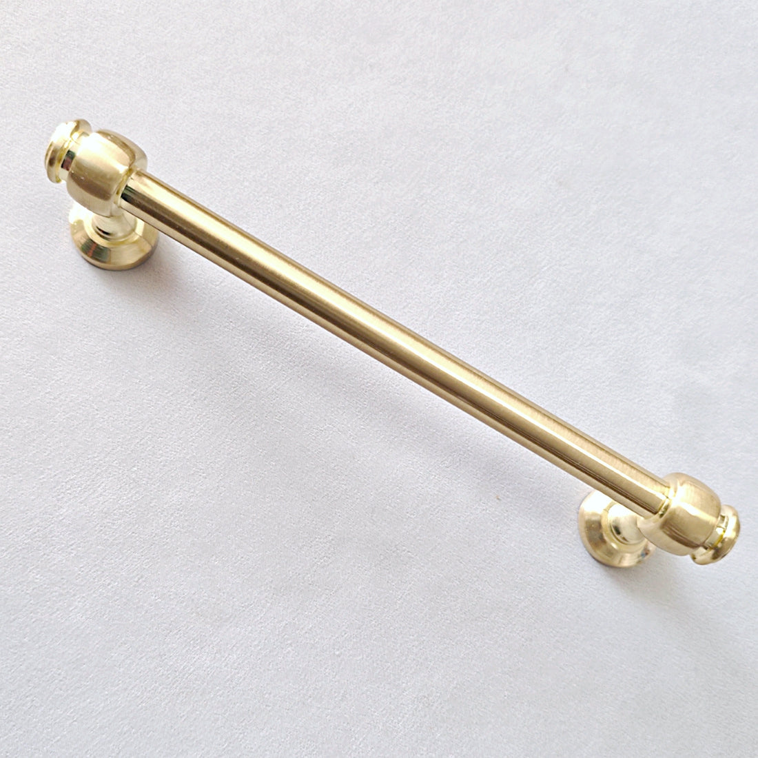 6 inch centers Gold cabinet round bar handle on a light gray background