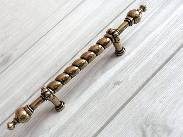 mid century Decorative brass handle on a wooden surface