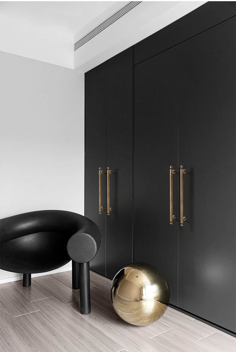 Antique bronze bar handles on black cupboard