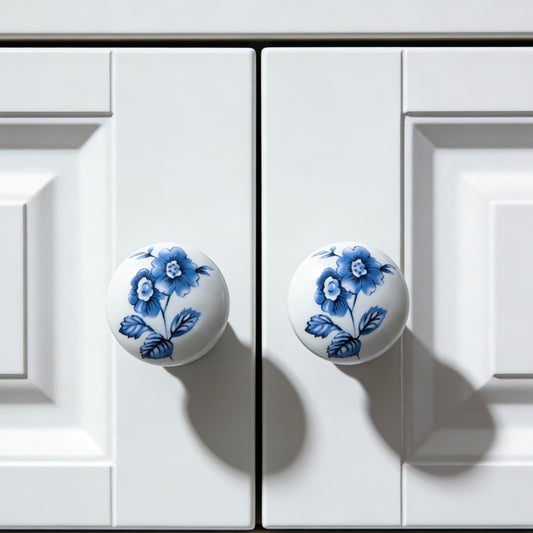 White cabinet doors with blue floral knobs on a white background