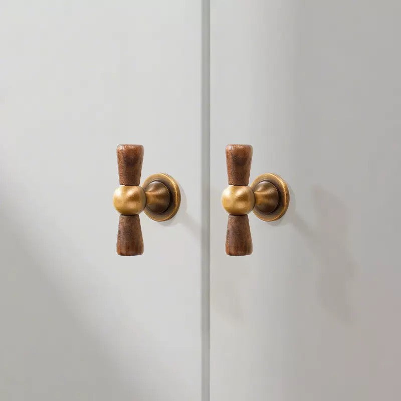 Walnut wood and brass asian inspired crossed knobs