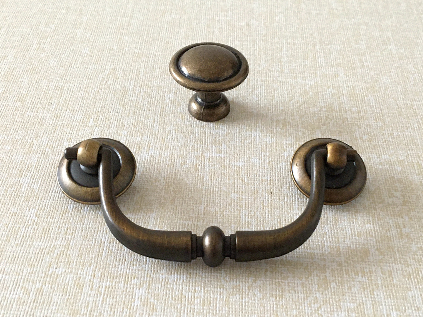 farmhouse style antique gold swing bail pull and round cabinet knob