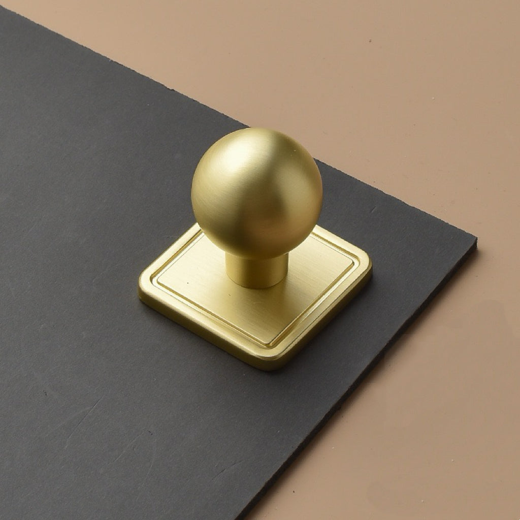 brushed gold spherical drawer knob with square back plates