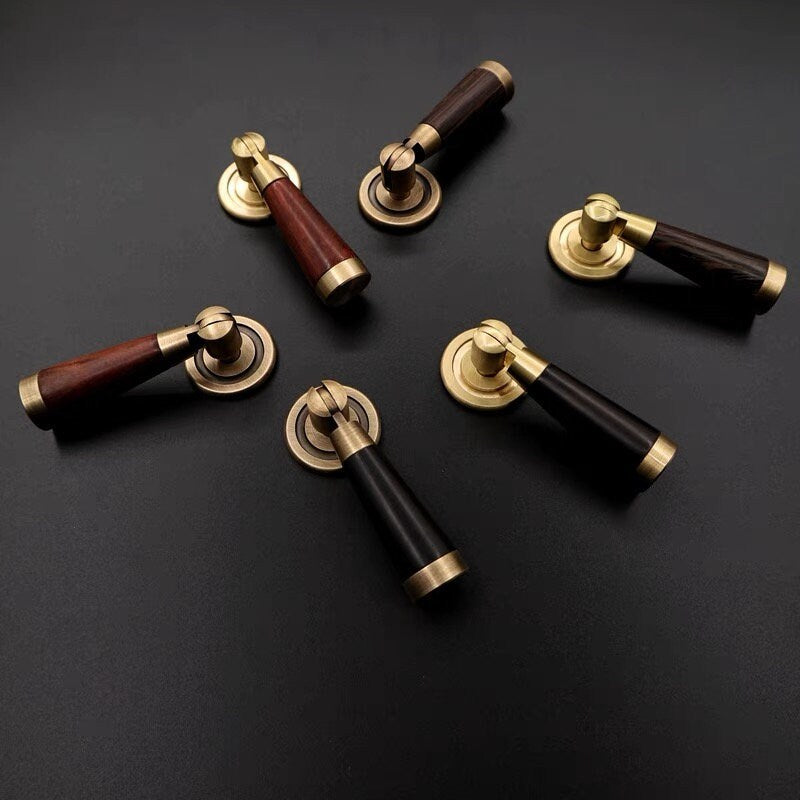 wood and brass cabinet drop pulls on a dark background