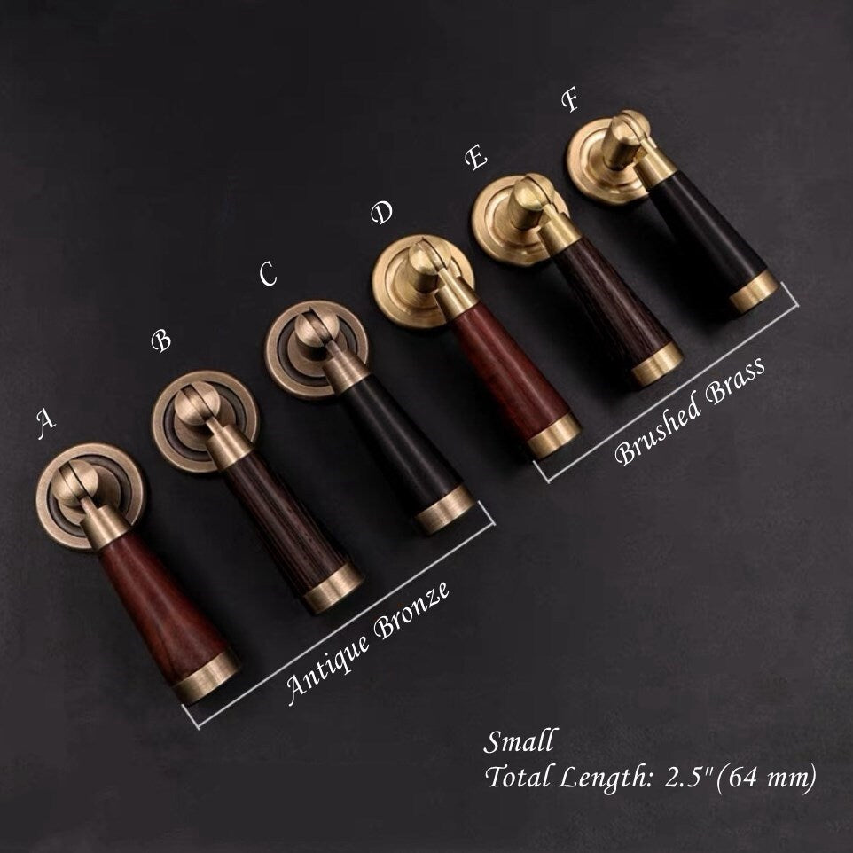 Set of wood and brass door handles with different finishes on a dark background