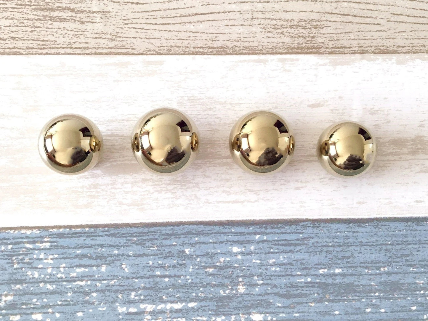 solid brass spherical knobs in polished brass finish