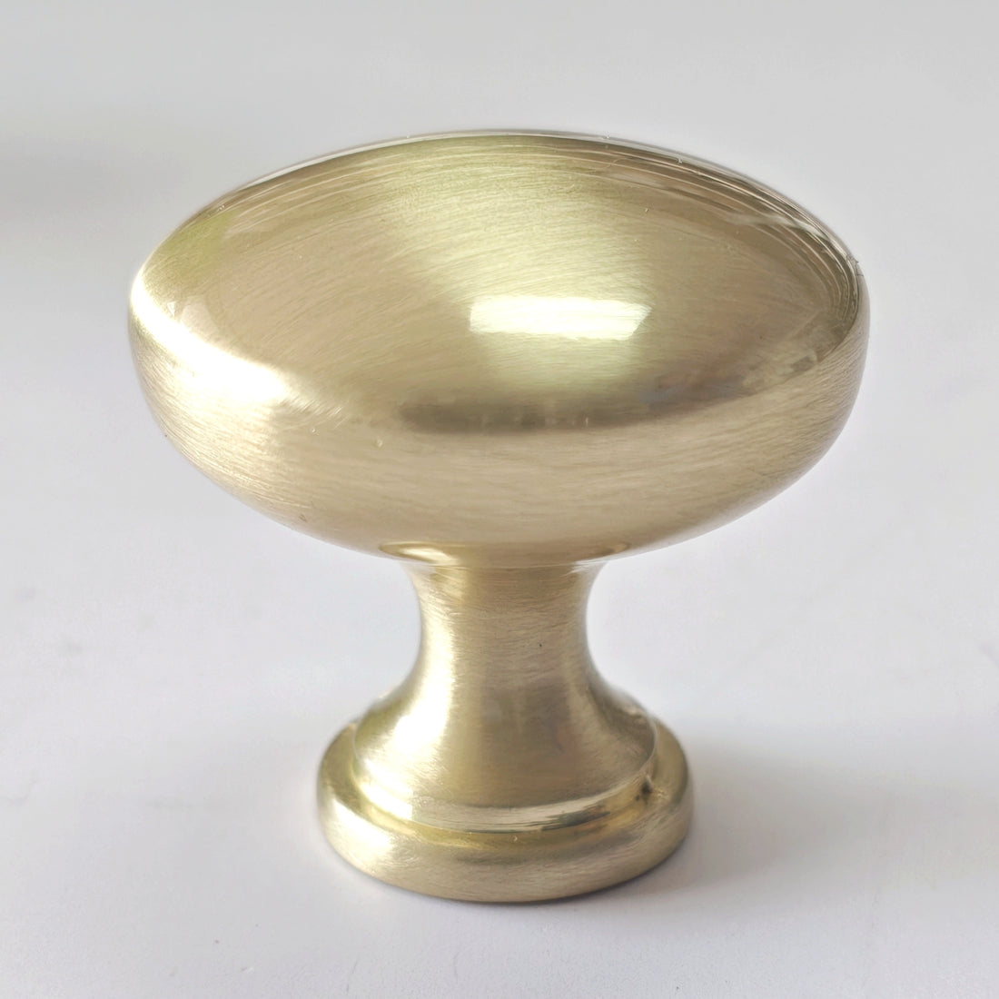 Brass cabinet knob on a white background