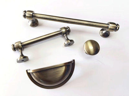 Set of brass antique bronze cabinet handles, cup drawer pulls and knobs on a white background