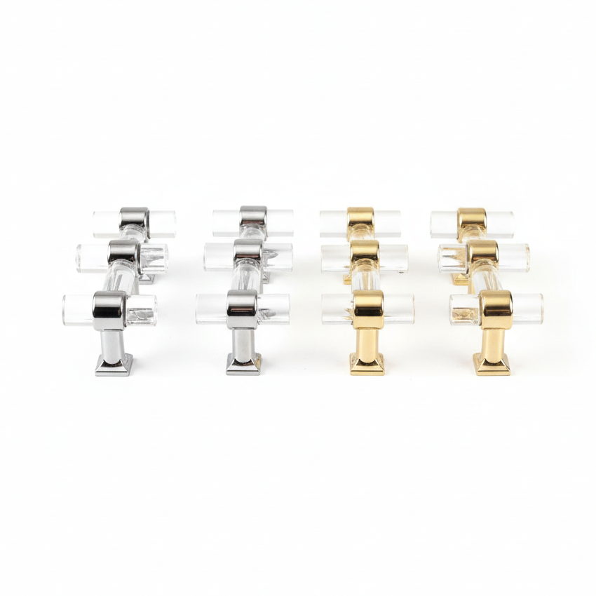 Set of four clear acrylic handles with gold and silver metal accents on a white background