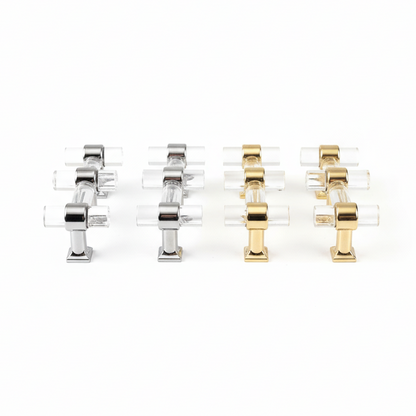 Set of four clear acrylic handles with gold and silver metal accents on a white background