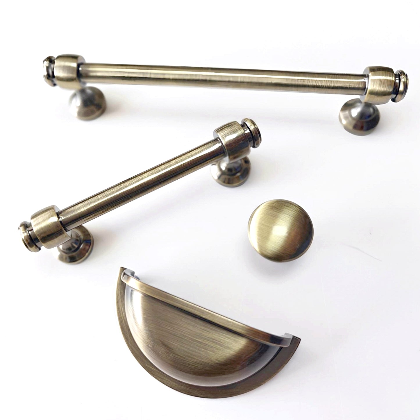 Set of brass cabinet handles on a white background