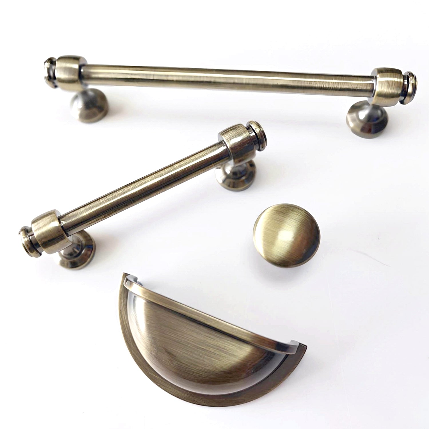 Set of brass cabinet handles on a white background
