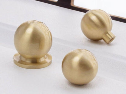 Three gold spherical knobs for modern home decor
