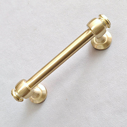 Gold cabinet round bar handle on a light gray background
