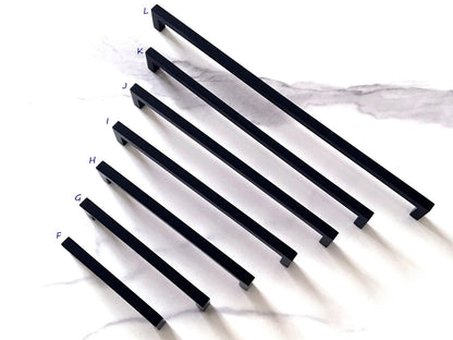 Set of black cabinet square bar handles on a white background