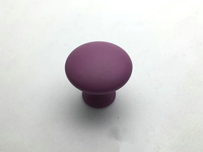Purple cabinet knob on a white background