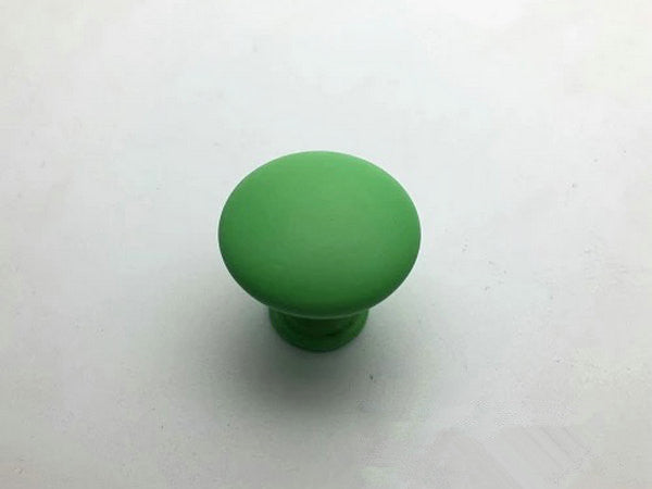 Green furniture knob on a white background