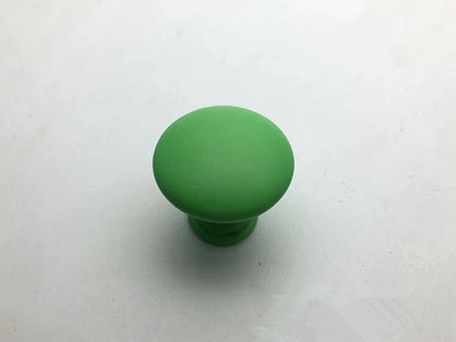 Green furniture knob on a white background