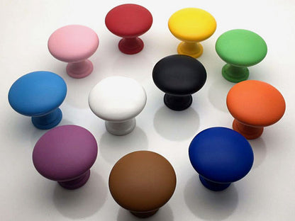Assorted colorful cabinet knobs on a white background