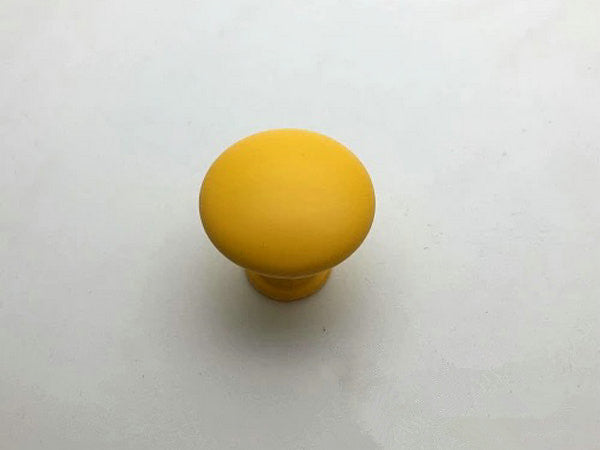 Yellow cabinet knob on a white background