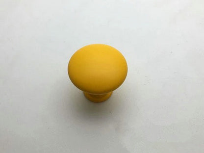 Yellow cabinet knob on a white background