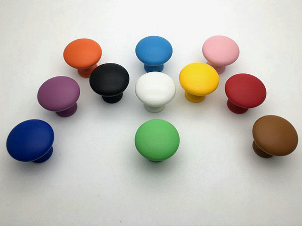 Colorful cabinet knobs arranged on a white background