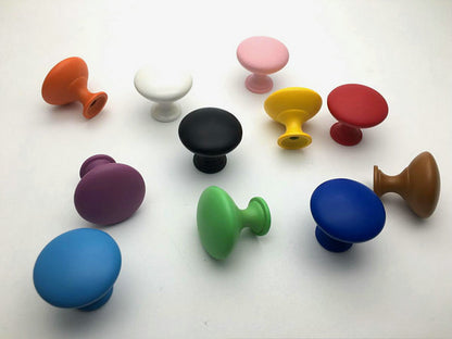 Assorted colorful cabinet knobs on a white background