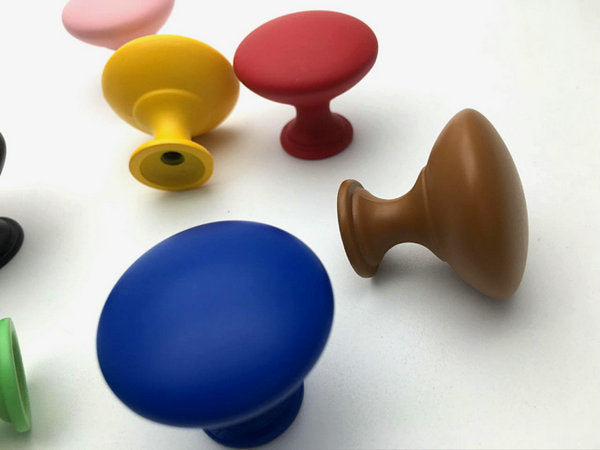 Colorful drawer knobs on a white background