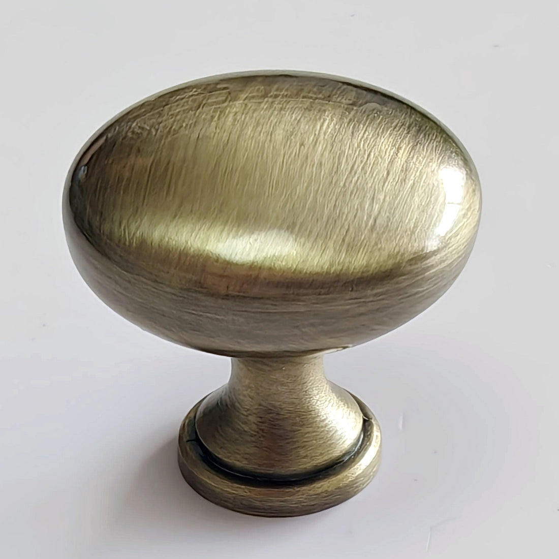 Brass cabinet knob on a white background