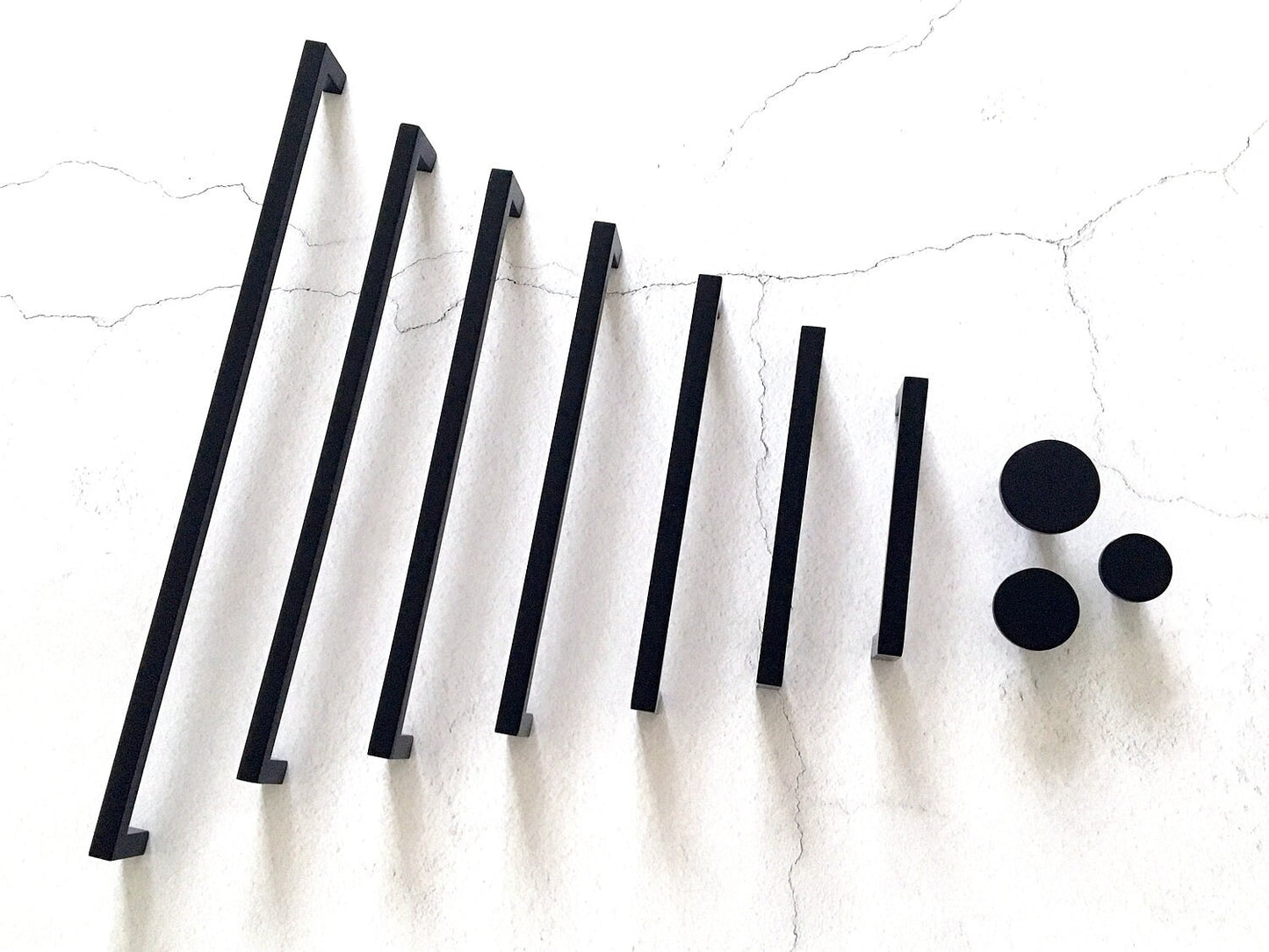 Set of black bar handles and circular knobs