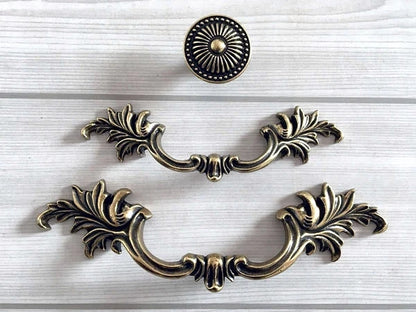 Decorative brass cabinet handles on a white background