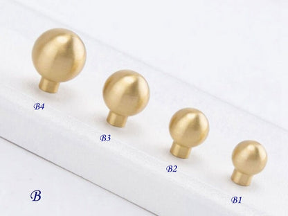 Set of gold spherical knobs on a white background