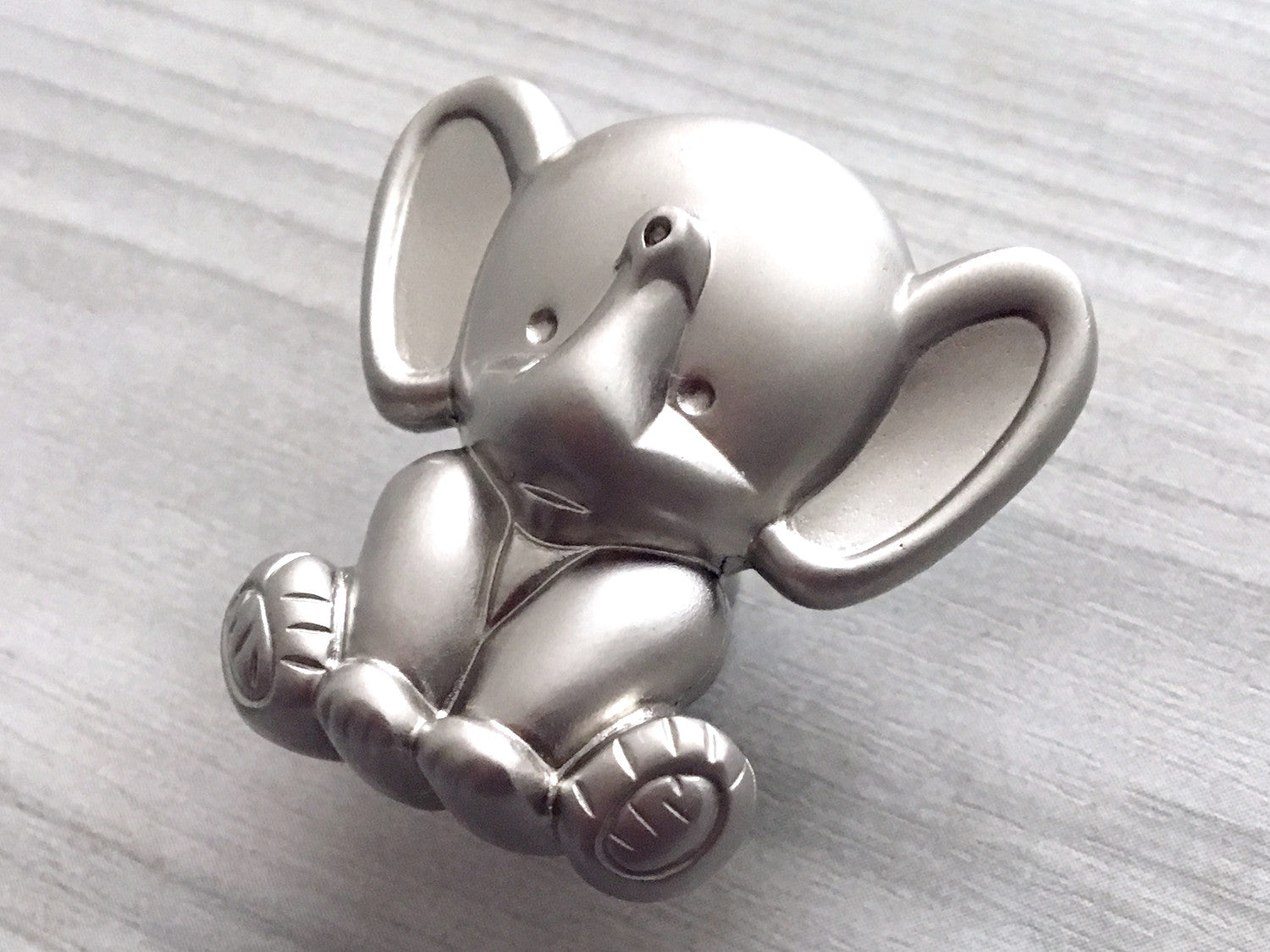 Silver elephant nursery knob on a light gray background