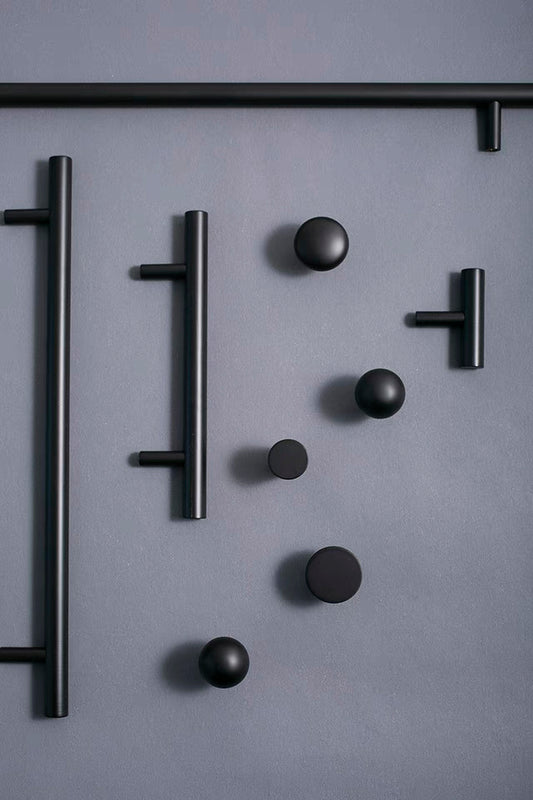 Set of black round drawer knobs and kitchen bar pulls for minimalist home decor 