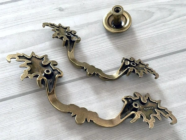 Decorative brass hardware on a light wooden surface