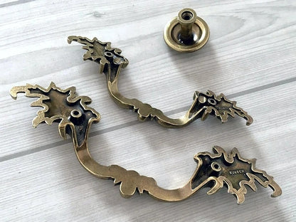 Decorative brass hardware on a light wooden surface