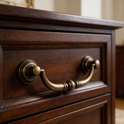 Close-up of a wooden drawer with antique bronze swing bail handle