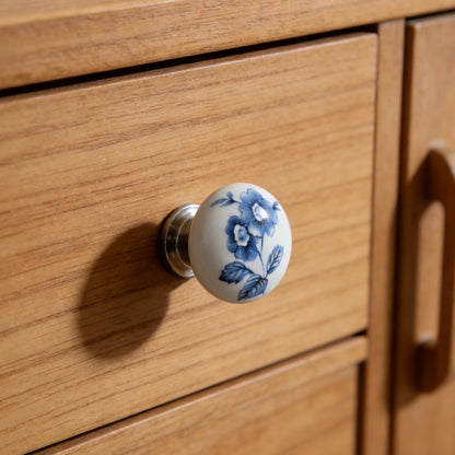 Wooden drawer with a decorative blue floral porcelain knob