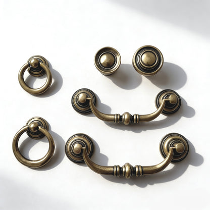 Set of vintage-style antique bronze cabinet handles on a white background