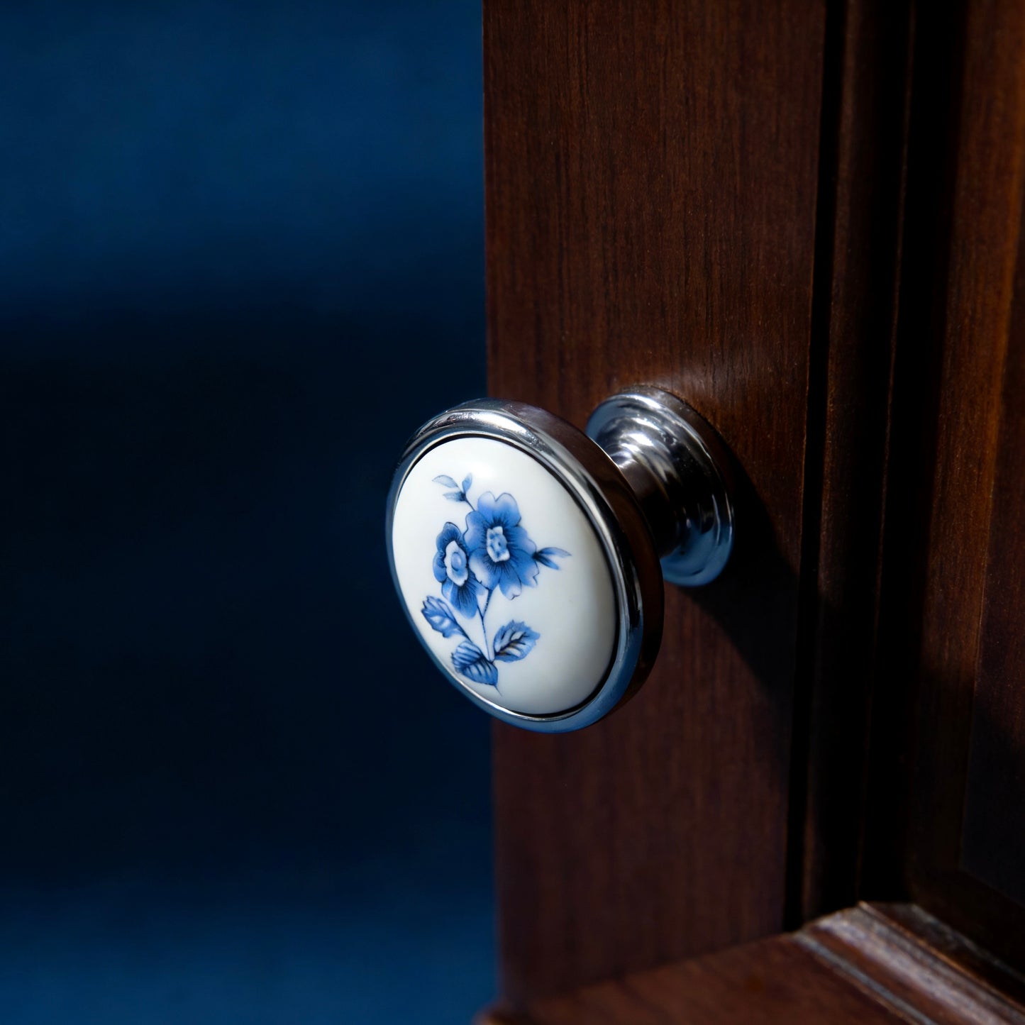 ceramic Door handle with floral design on a wooden door