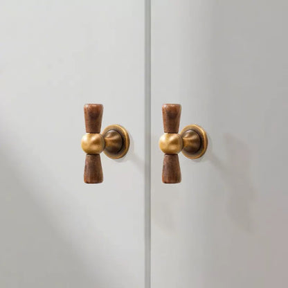 Walnut wood and brass asian inspired crossed knobs 