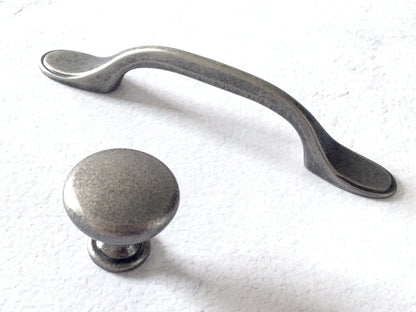 Pewter cabinet handle and knob on a white background