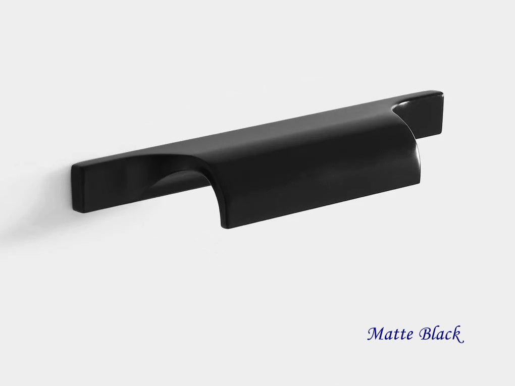 Matte black cabinet handle on a light gray background