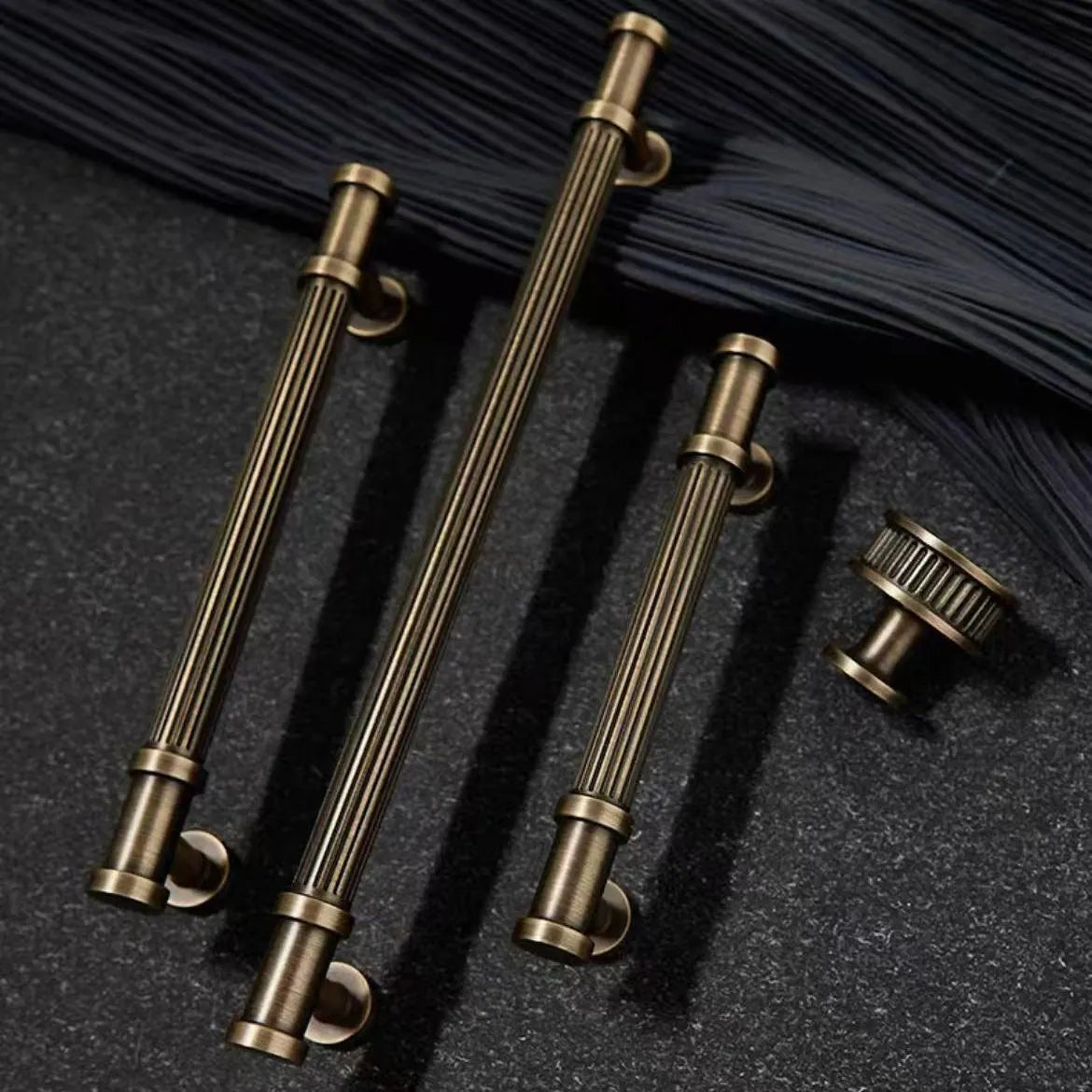 Set of reeded bronze cabinet handles and a matching knob