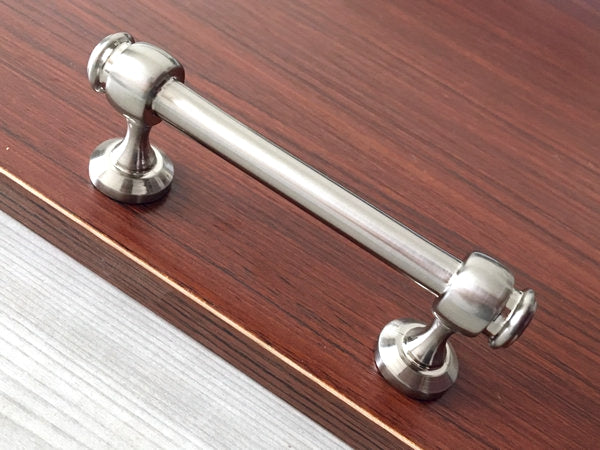 Brushed nickel door handle on a wooden door
