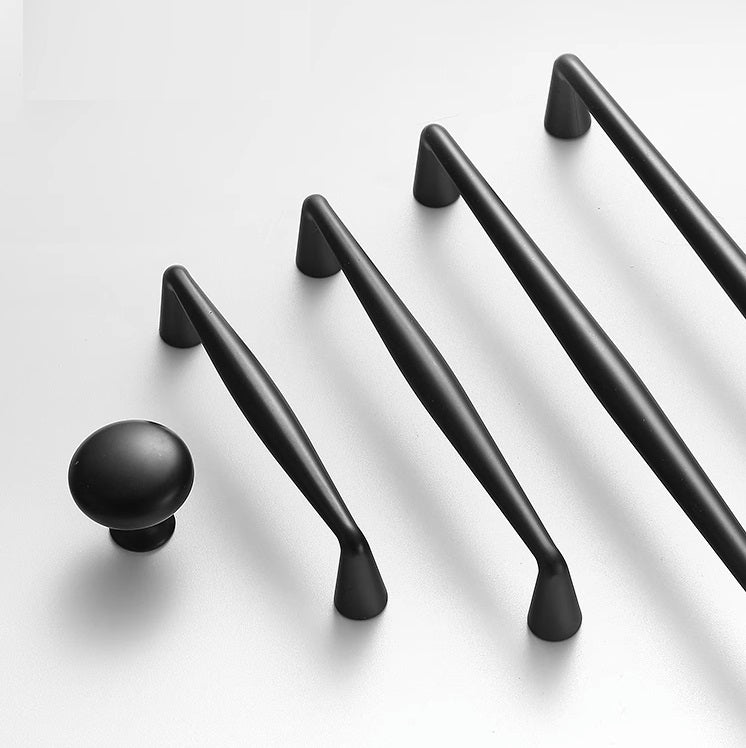 Set of black cabinet handles and knobs on a white background