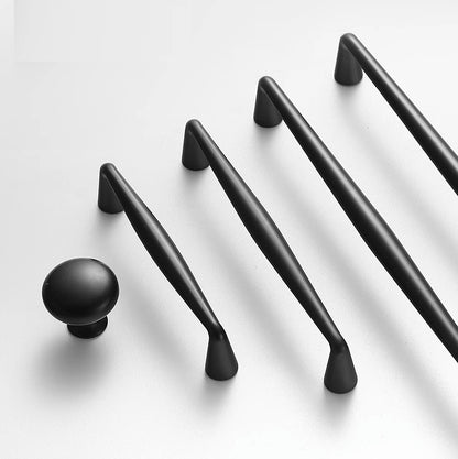 Set of black cabinet handles and knobs on a white background